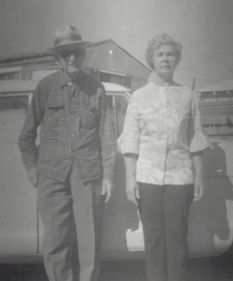 Claude Taylor and Rachel Downing standing by a truck.